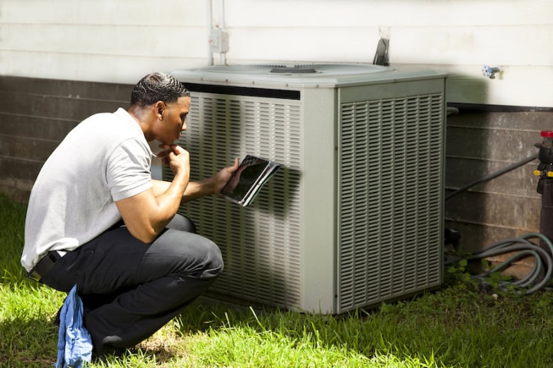 3 Tips to Prevent an AC Breakdown During a Heat Wave. AC technician.